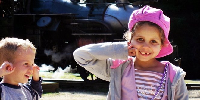 CLICK to continue: Sofia holding her ears while the steam train goes past